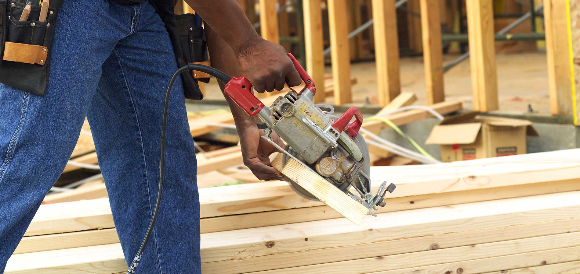 Construction worker cutting wood