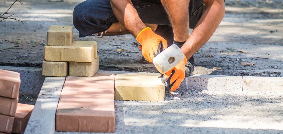 Worker laying new brick