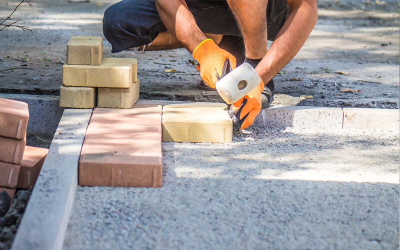 Construction worker laying brick